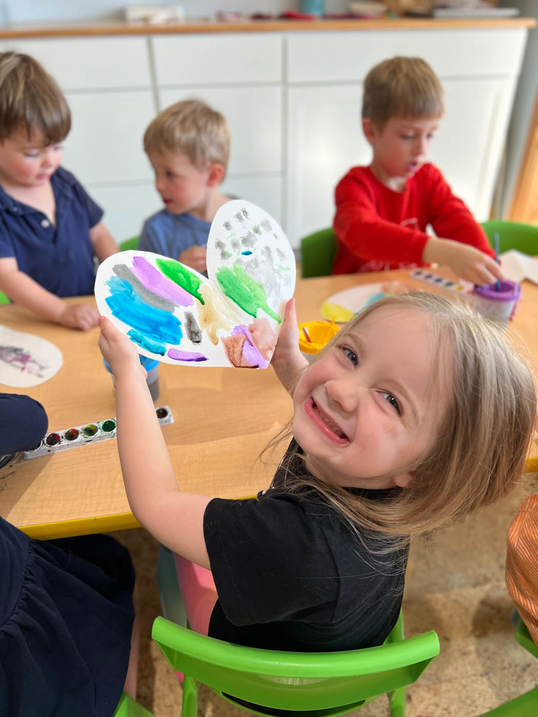 A young girl making art with Kids Garden.