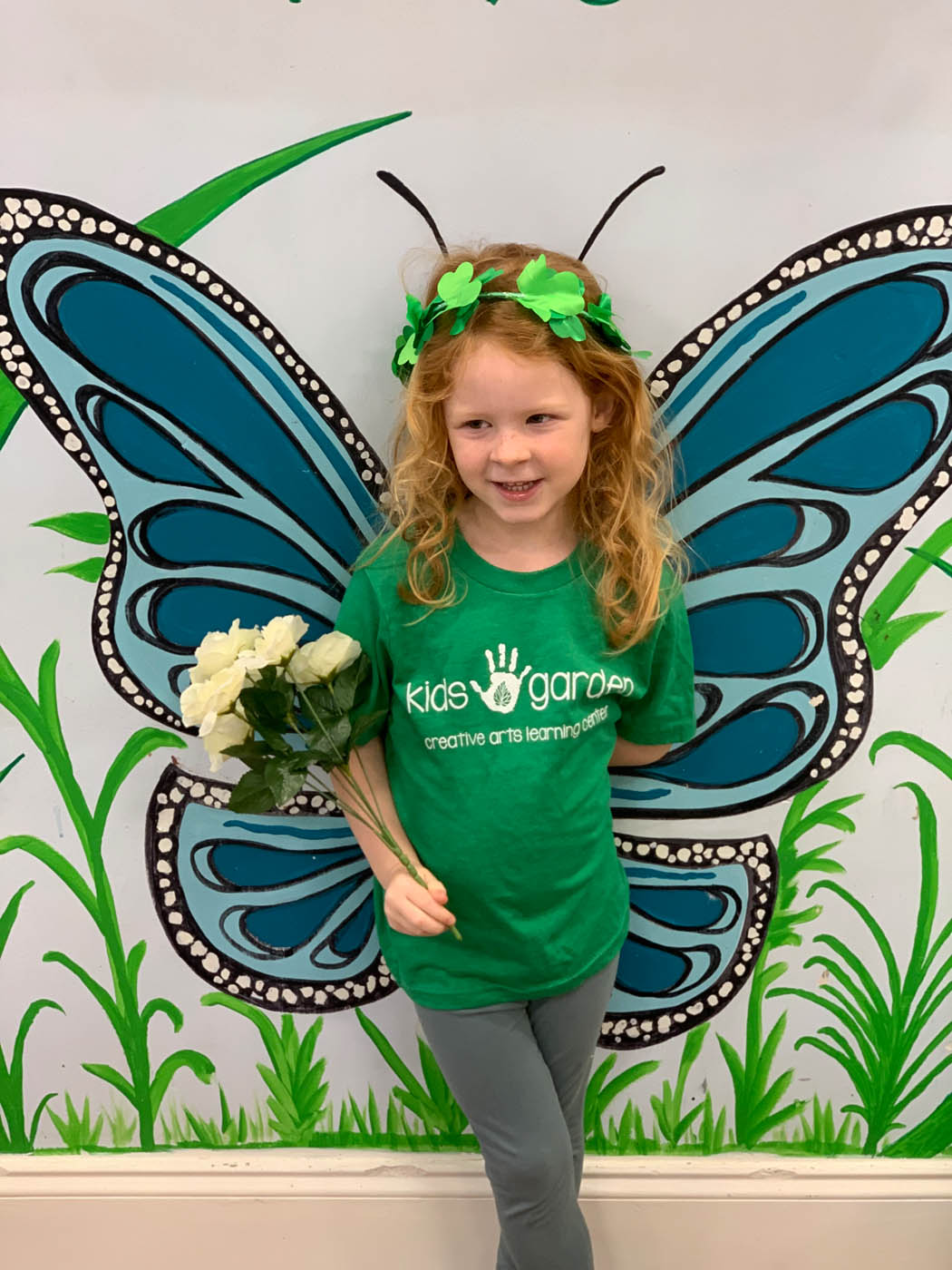 Little girl in front of a butterfly painting in Summerville, SC.