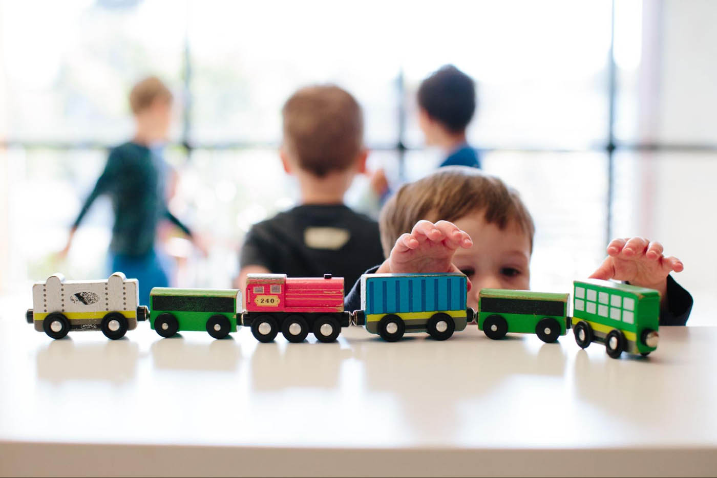 A child at Kids Garden playing with a train during part time daycare.