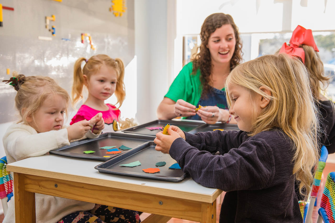 A teacher working on teaching shapes with a group of kids at our early childhood education in Asheville, NC.