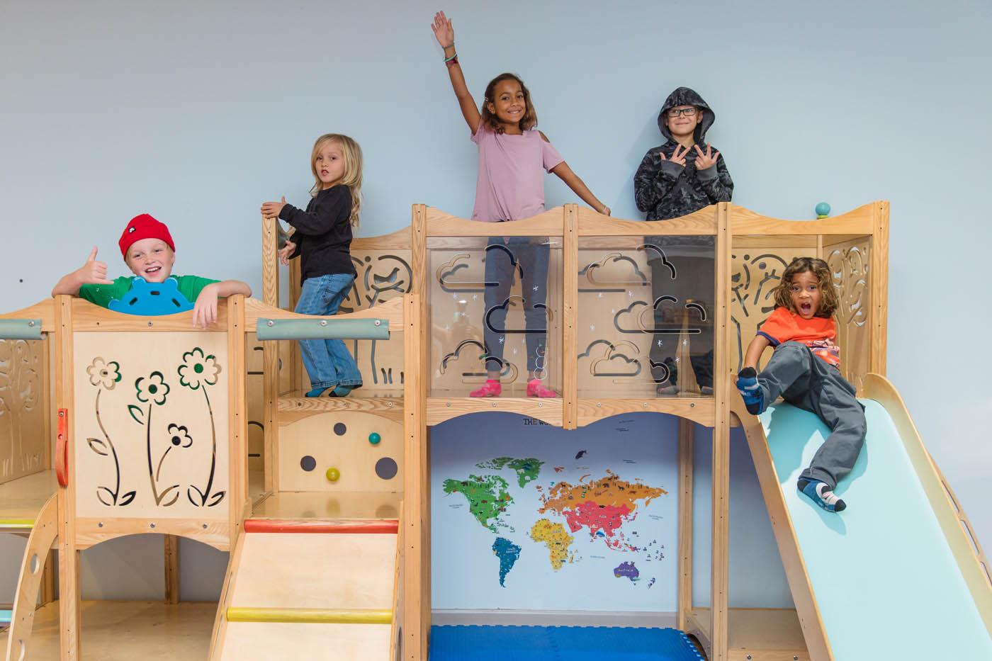 A group of kids playing on Kids Garden's indoor playground, one of the many things to do with kids in Houston, TX.