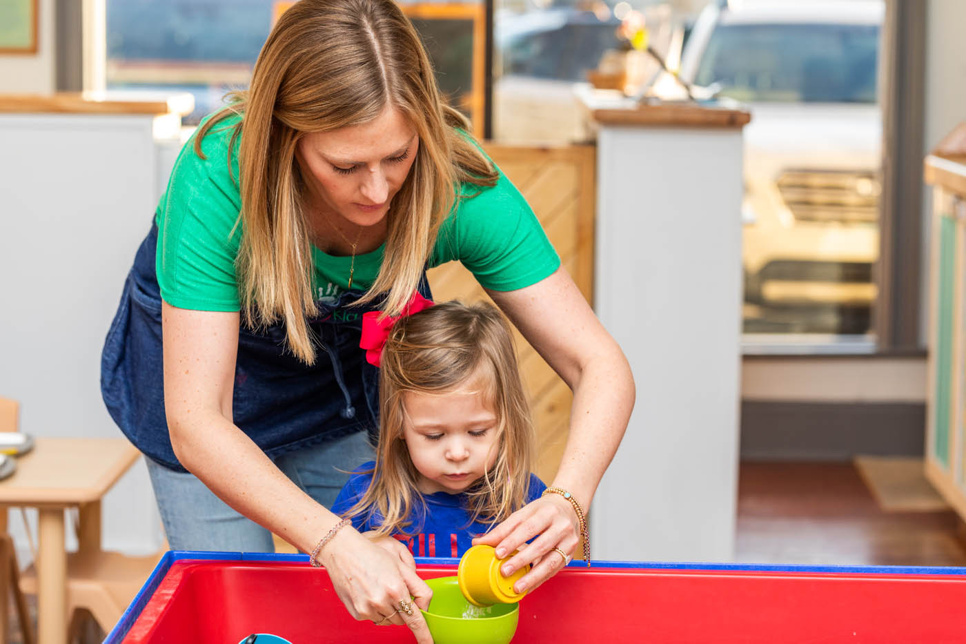 A child being led by a teacher during half day preschool.