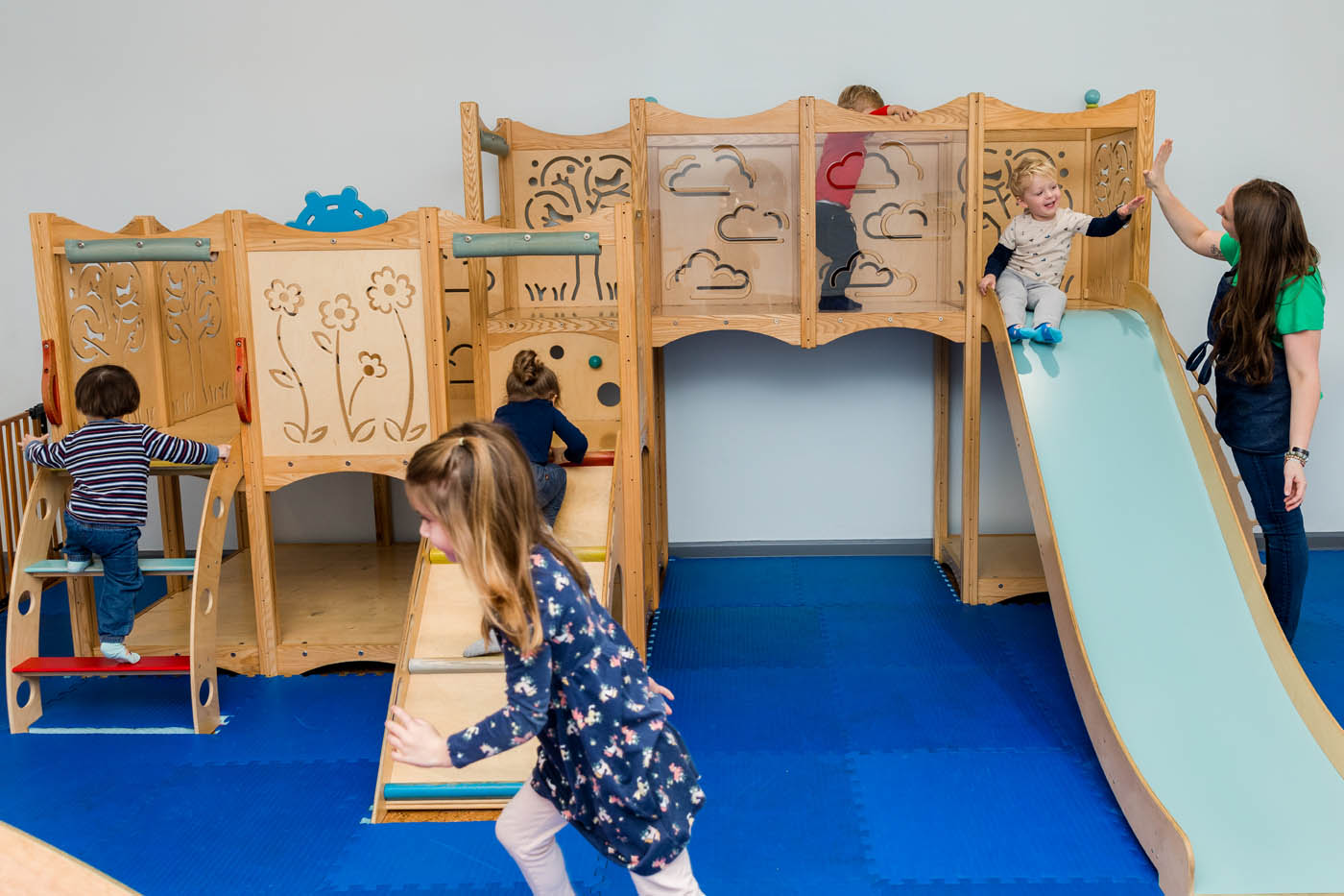 Kids on a playground at Kids Garden play based preschool.