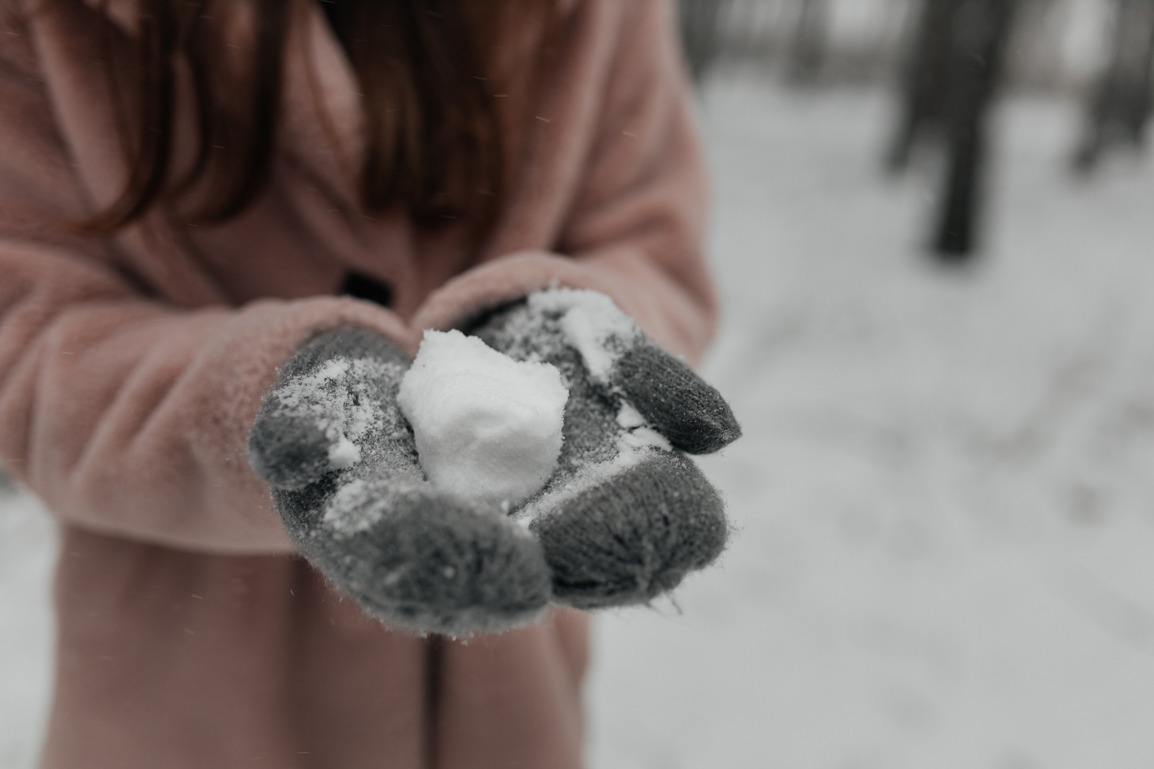 A girl holding a snow ball - Kids Garden is the best Montessori preschool in Charleston, SC.