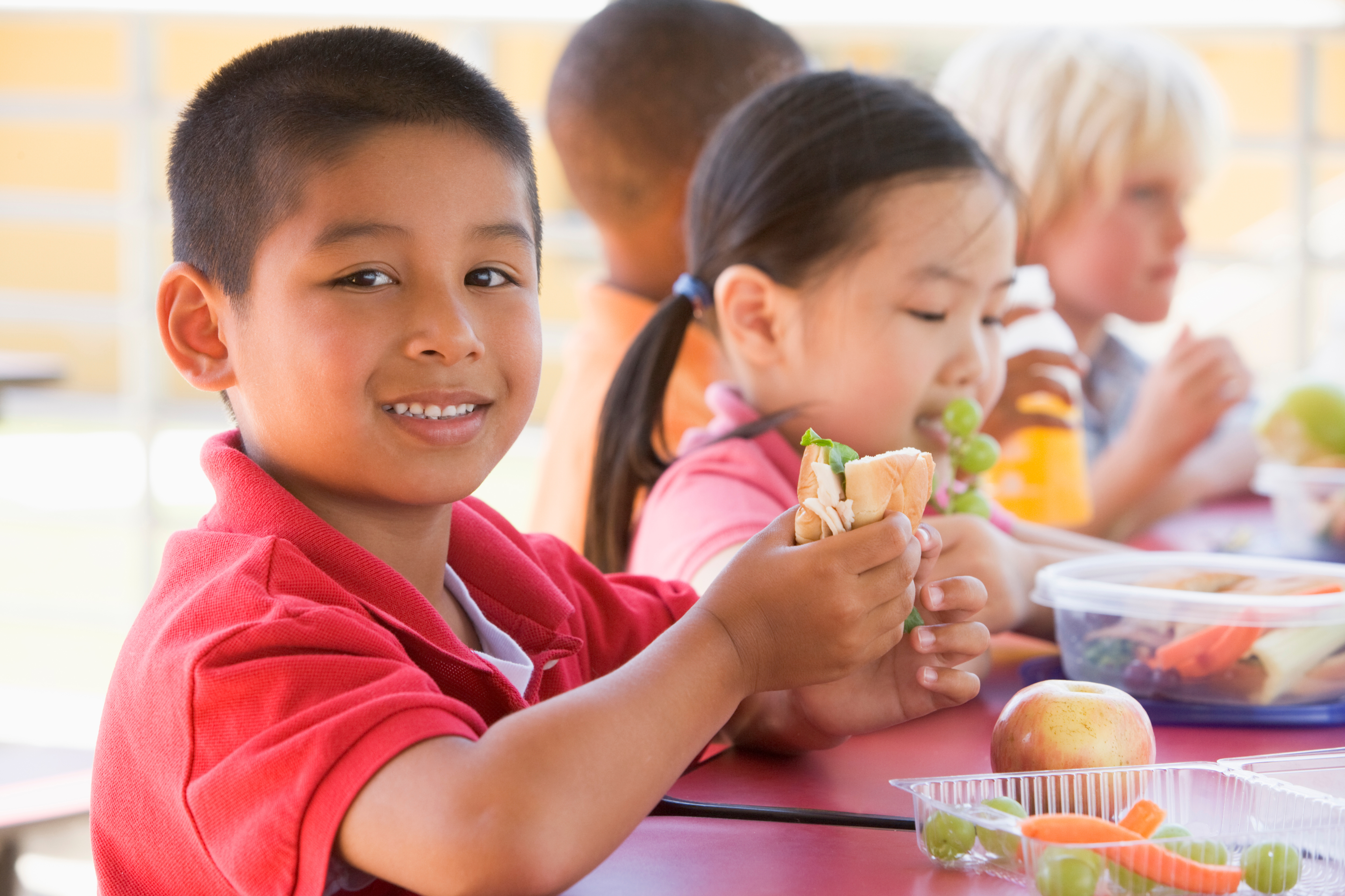 Children eating a healthy meal prepared at Kids Garden Asheville.