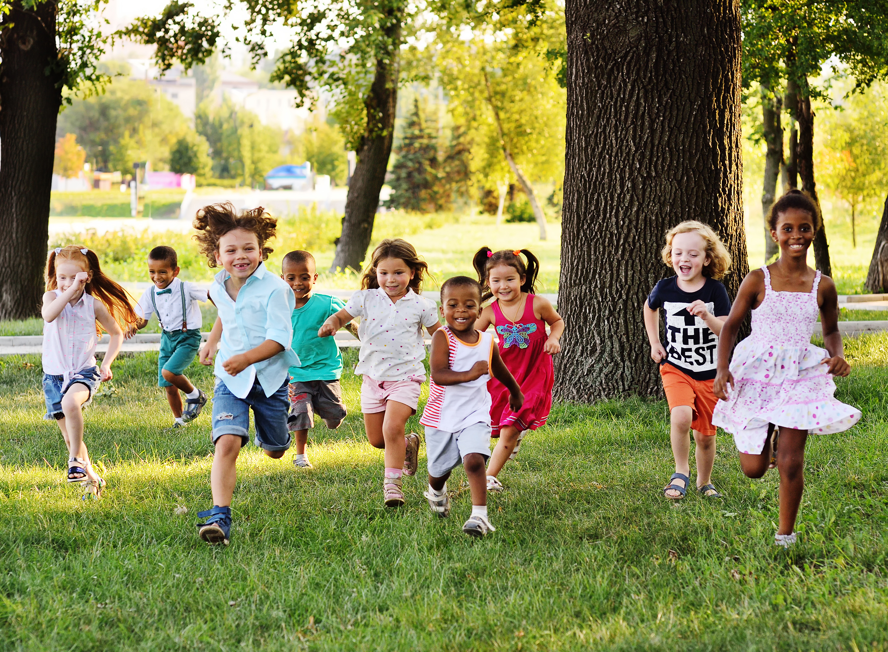 A group of kids running and having fun at a Kids Garden Asheville summer camp.